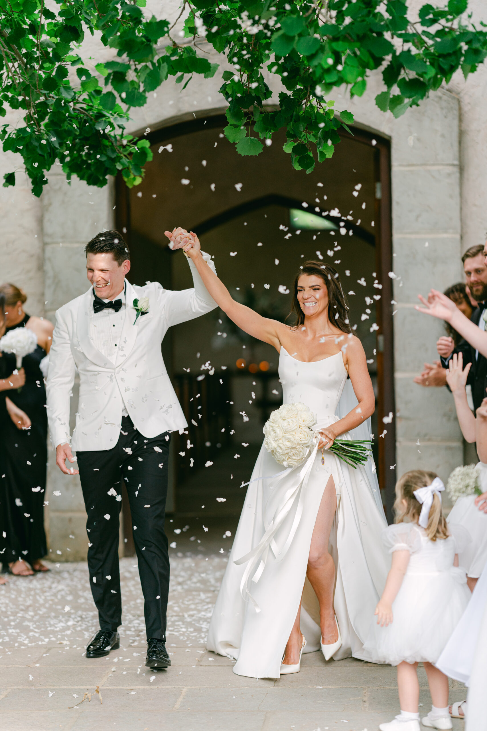 Couple exiting wedding ceremony with petal toss