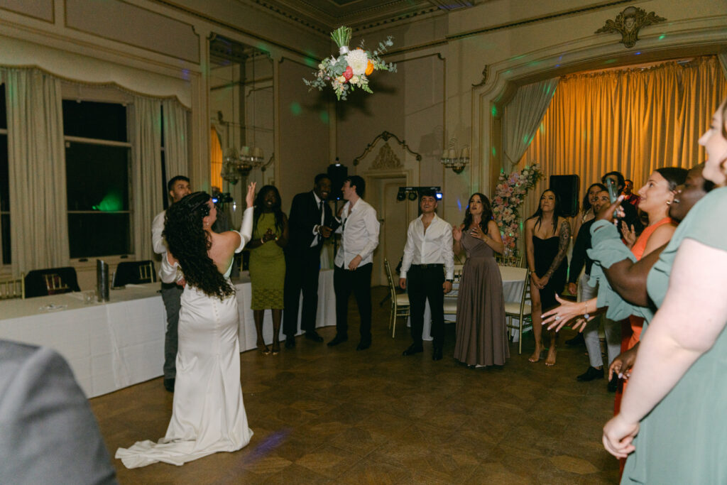 Bride tossing her bouquet at Ripponlea Estate